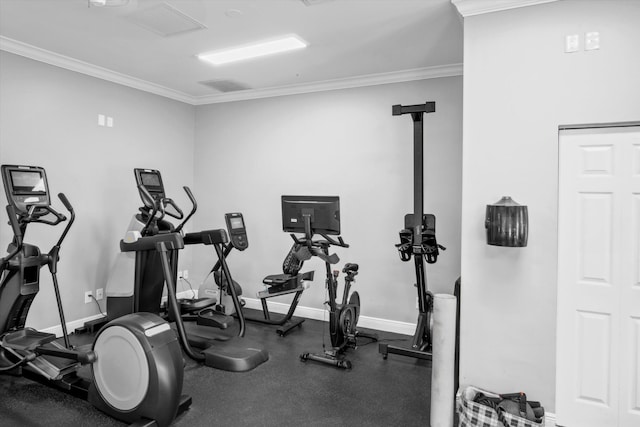 exercise area featuring baseboards and crown molding