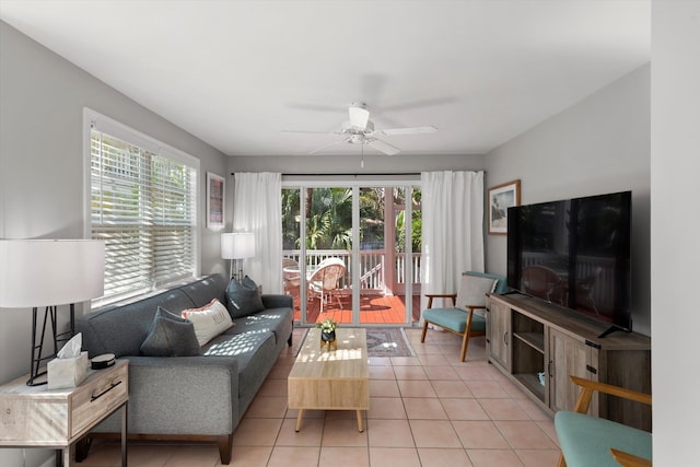 living room with light tile patterned floors, plenty of natural light, and a ceiling fan