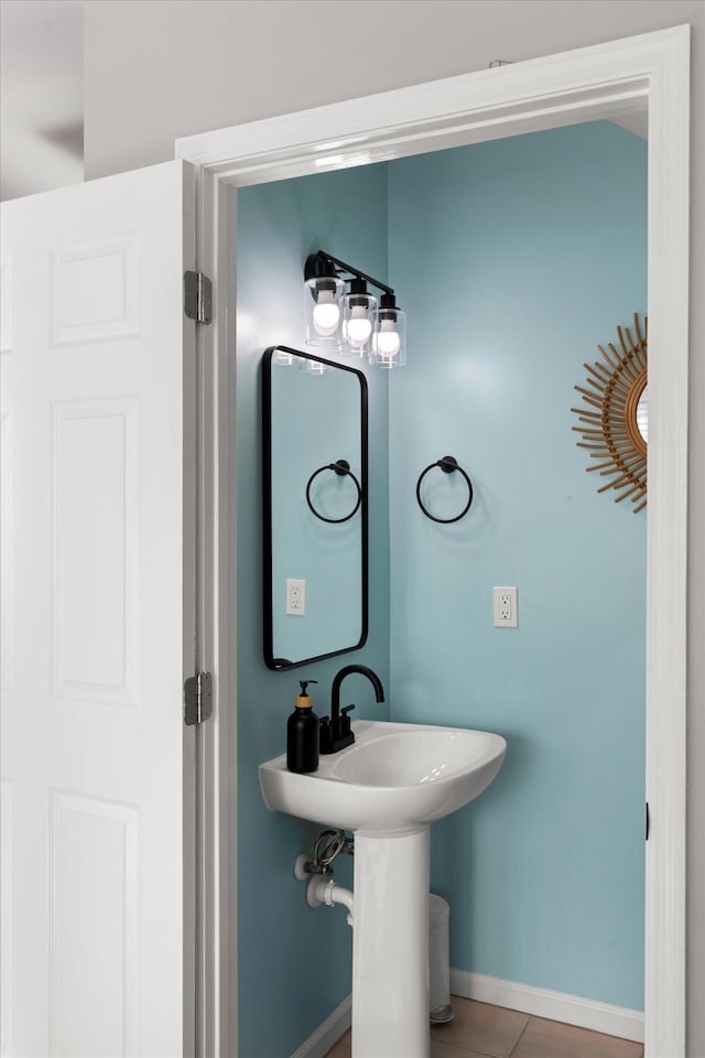 bathroom with baseboards and tile patterned floors