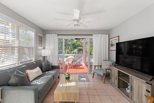 living area featuring ceiling fan and light tile patterned flooring