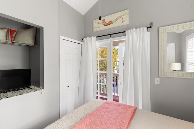 bedroom featuring lofted ceiling and a closet