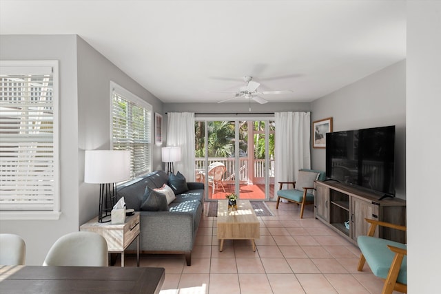 living area with light tile patterned floors, ceiling fan, and a wealth of natural light