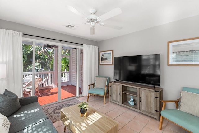 living room featuring light tile patterned floors, ceiling fan, and visible vents