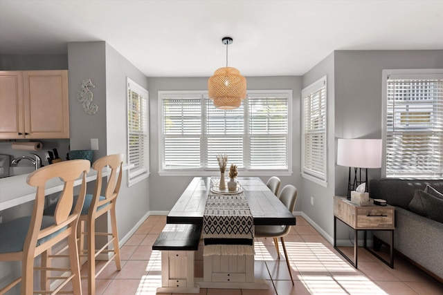 dining space with light tile patterned floors and baseboards