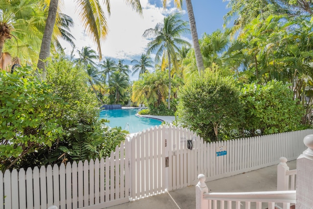 view of swimming pool with a gate, fence, and a fenced in pool