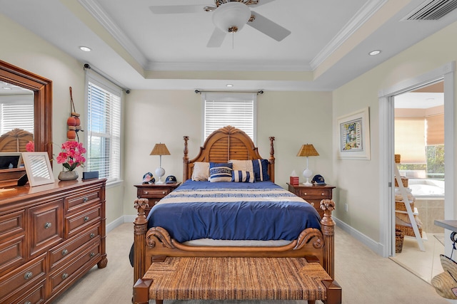 bedroom with ornamental molding, a tray ceiling, visible vents, and baseboards