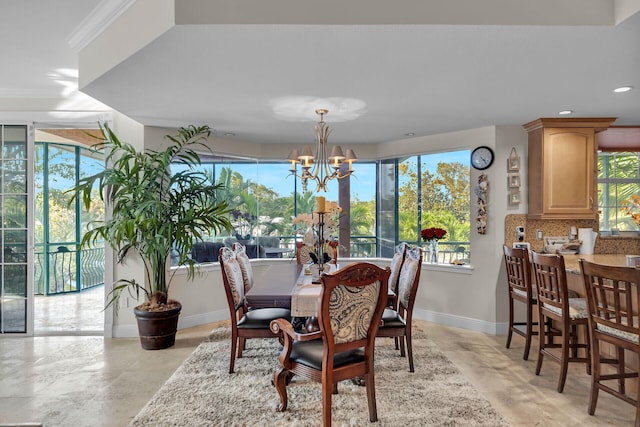 dining area with a chandelier, recessed lighting, crown molding, and baseboards