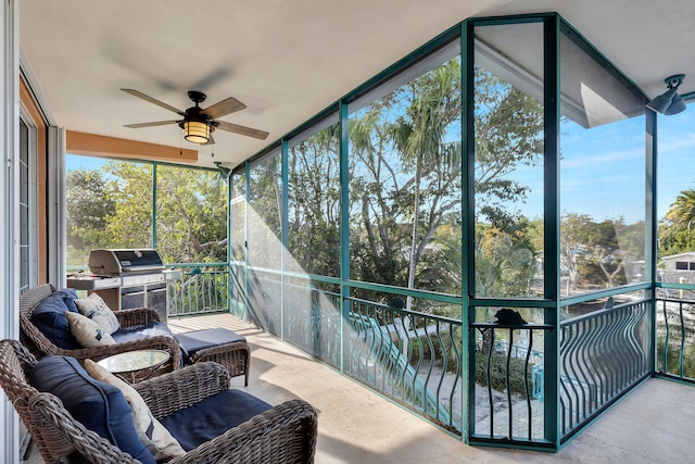 sunroom / solarium featuring plenty of natural light and ceiling fan