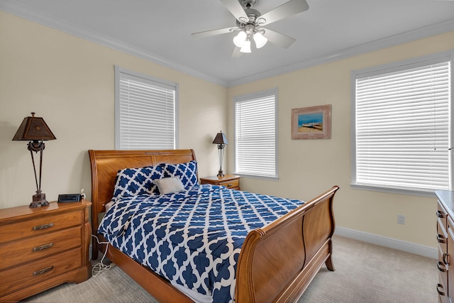 bedroom featuring light carpet, ceiling fan, baseboards, and crown molding