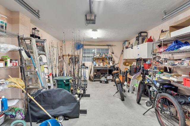 garage featuring a garage door opener and a workshop area