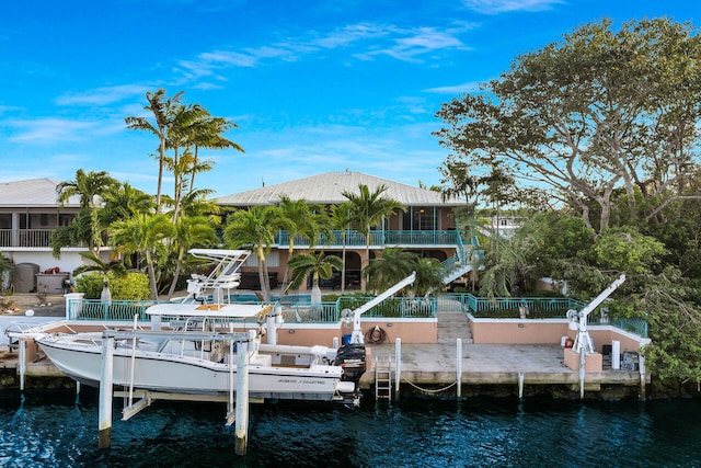 dock area featuring stairway, a water view, fence, and boat lift