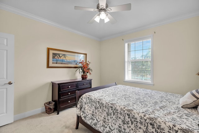 bedroom with a ceiling fan, light carpet, crown molding, and baseboards