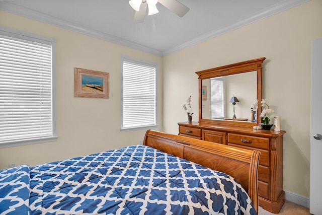 carpeted bedroom with ornamental molding, ceiling fan, and baseboards