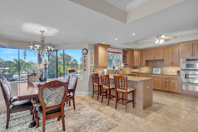 dining room with recessed lighting, a raised ceiling, ornamental molding, baseboards, and ceiling fan with notable chandelier