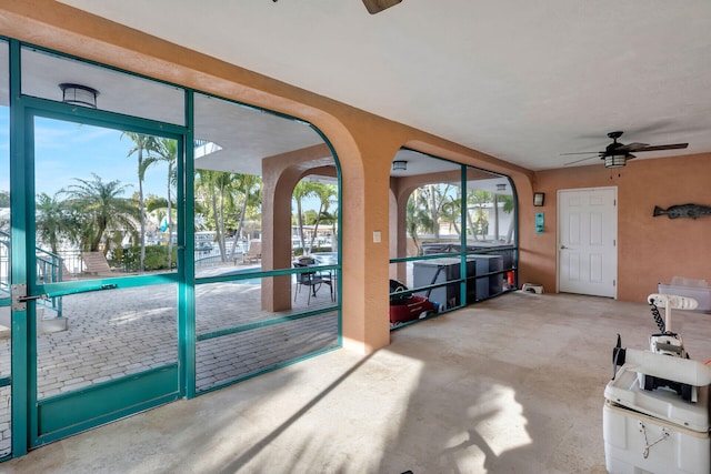 interior space featuring concrete floors and a ceiling fan