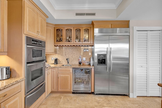 kitchen featuring wine cooler, crown molding, a warming drawer, appliances with stainless steel finishes, and light brown cabinets