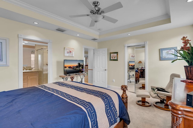 carpeted bedroom with ornamental molding, a raised ceiling, and visible vents