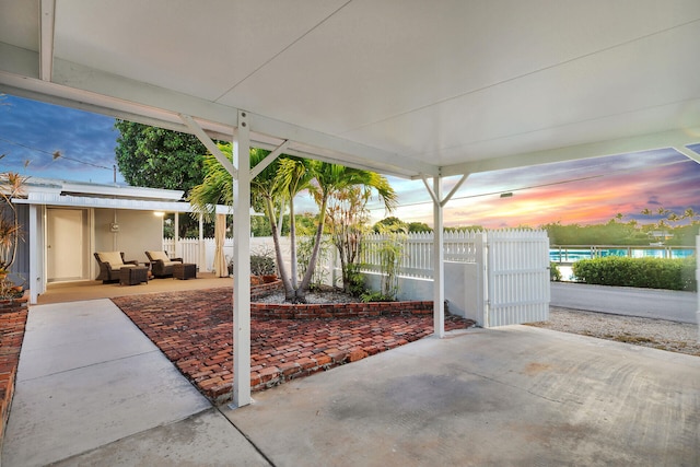 patio terrace at dusk featuring an outdoor hangout area