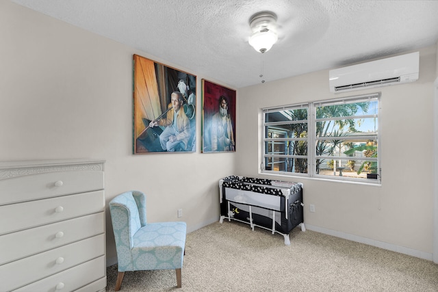 sitting room with a wall mounted air conditioner, light colored carpet, and a textured ceiling