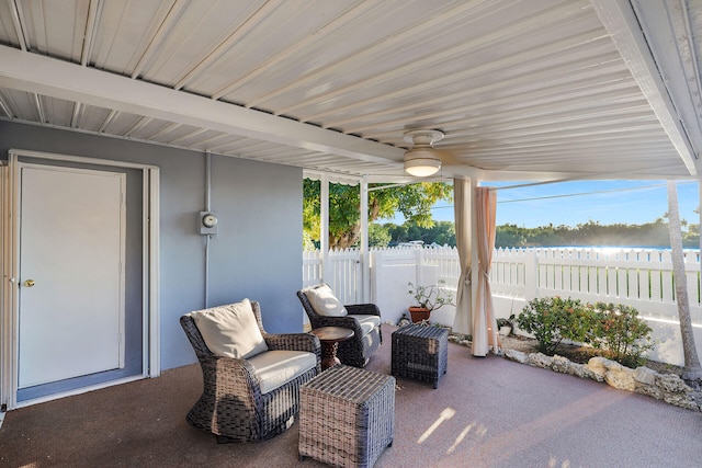 view of patio featuring a water view and ceiling fan