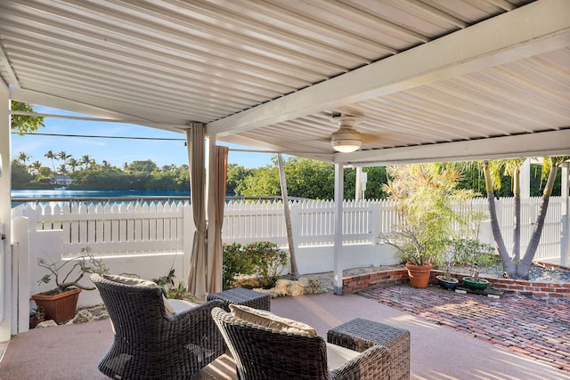 view of patio / terrace with a water view and ceiling fan