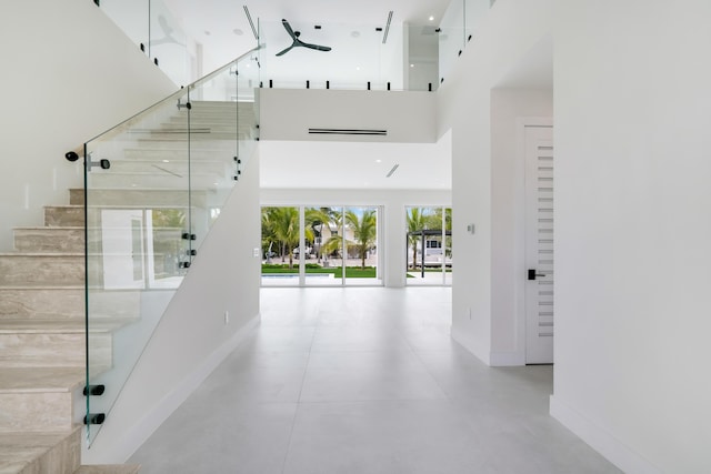 hallway featuring a towering ceiling