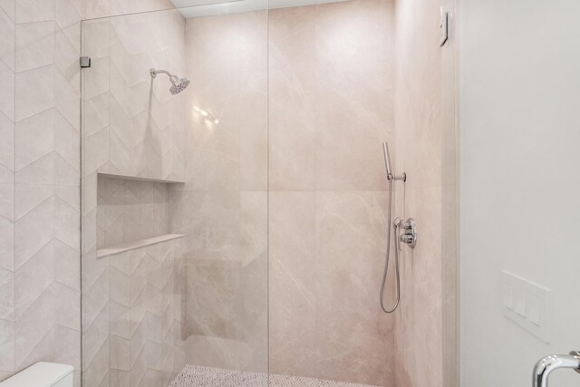 bathroom featuring a shower with shower door