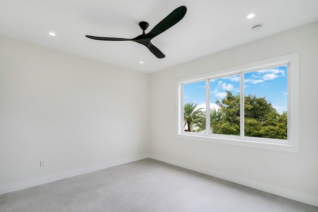 spare room featuring concrete flooring and ceiling fan