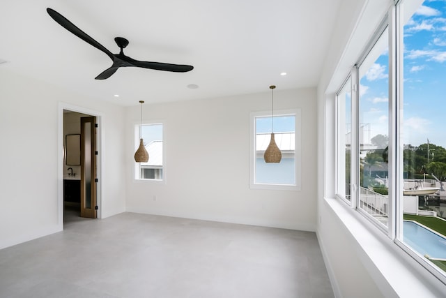 unfurnished room featuring ceiling fan and a healthy amount of sunlight