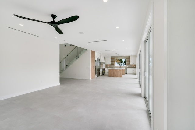 unfurnished living room featuring ceiling fan