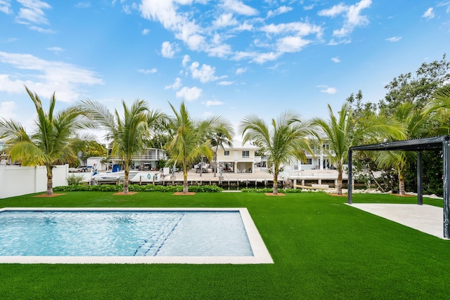 view of pool with a lawn