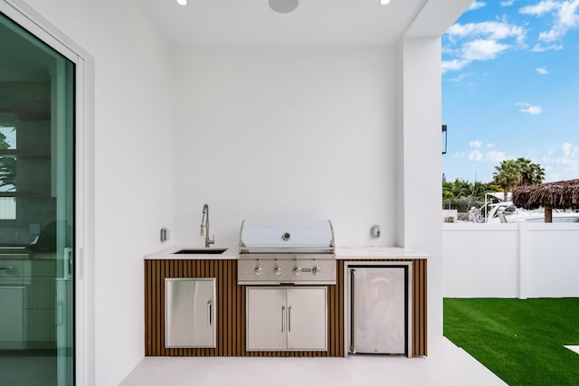 view of patio featuring area for grilling and sink