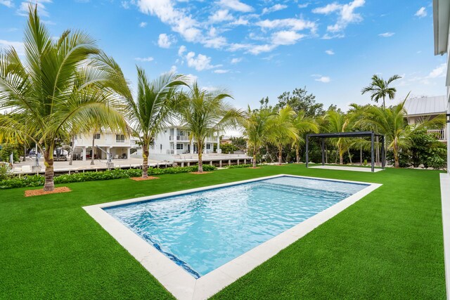 view of pool featuring a pergola and a yard