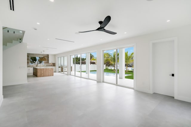 unfurnished living room with ceiling fan