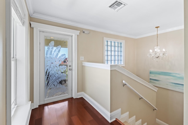 interior space featuring visible vents, baseboards, dark wood-style flooring, an upstairs landing, and a chandelier