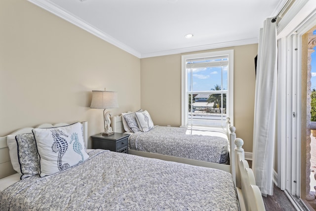 bedroom featuring crown molding and wood finished floors