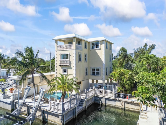 view of dock featuring a water view, a patio, and boat lift