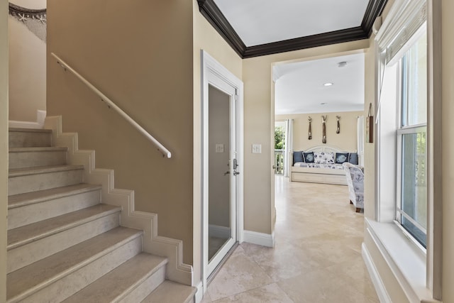stairway featuring ornamental molding and baseboards