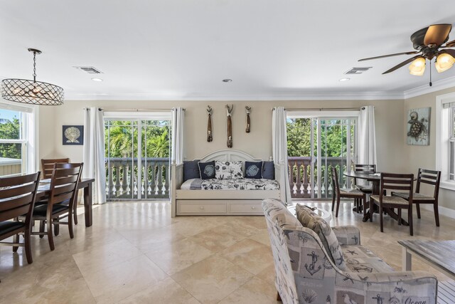 living room featuring visible vents, crown molding, and a healthy amount of sunlight