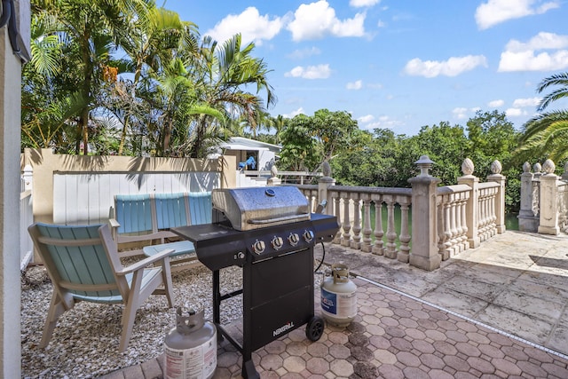 view of patio / terrace with fence and a grill