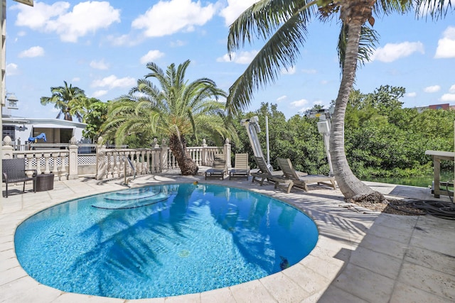 view of swimming pool featuring a fenced in pool and a patio