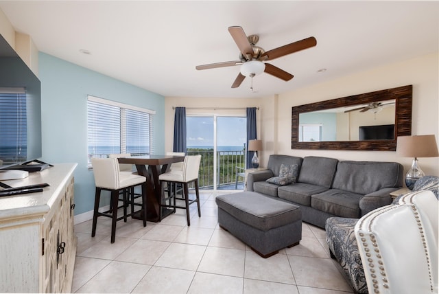 tiled living room with ceiling fan