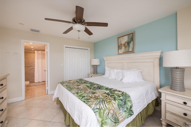 bedroom with light tile patterned flooring, ceiling fan, connected bathroom, and a closet