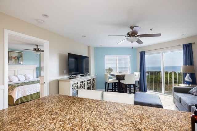 living room featuring light tile patterned floors and ceiling fan