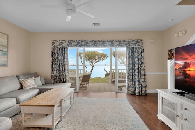 living room with dark wood-type flooring and ceiling fan