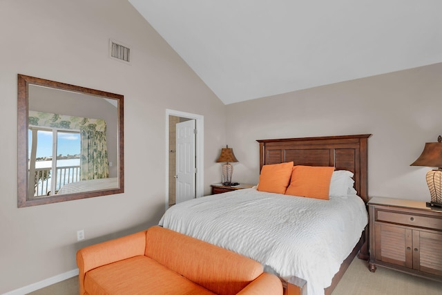 carpeted bedroom with high vaulted ceiling