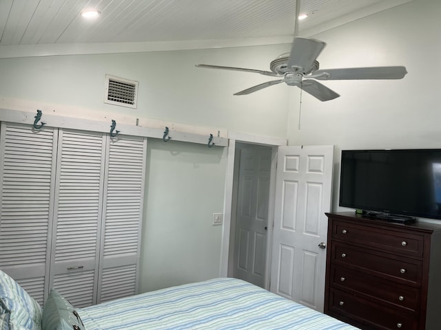 bedroom with lofted ceiling, a closet, and ceiling fan