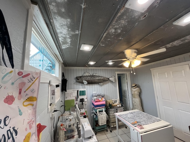 interior space with light tile patterned floors and ceiling fan