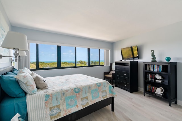 bedroom featuring baseboards and light wood-style flooring