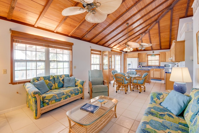 living area with light tile patterned floors, a wealth of natural light, and ceiling fan